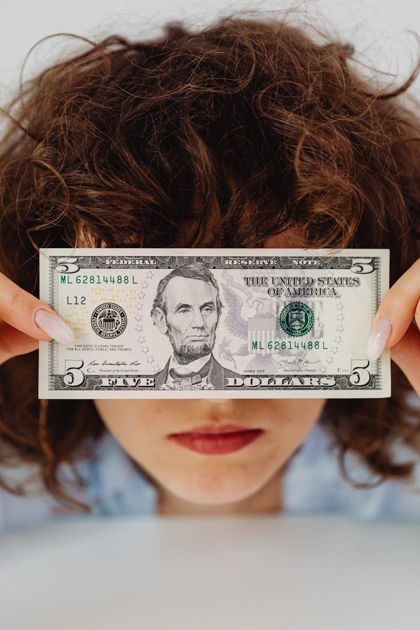 close up shot of a person holding paper money