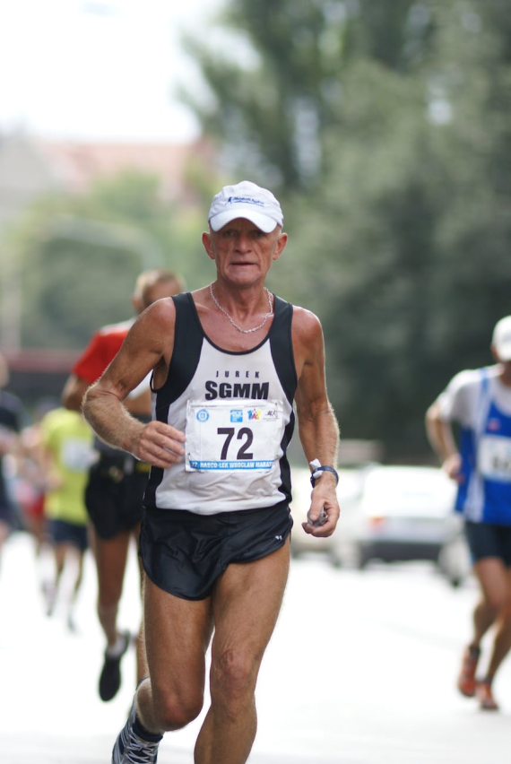 a man running in a marathon with a white shirt