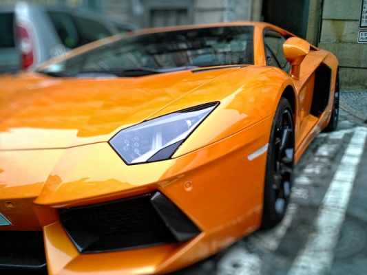orange lamborghini gallardo on park