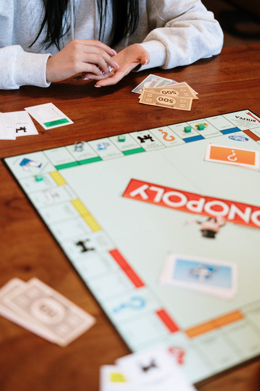 shallow focus of monopoly board game on brown wooden surface