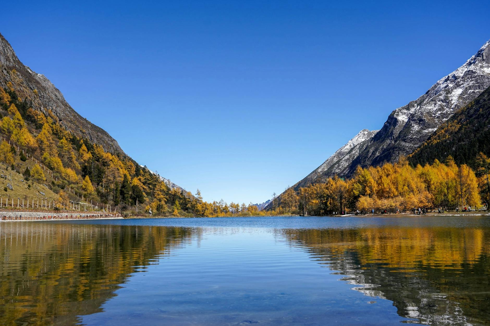 peaceful lake surrounded by autumn mountains