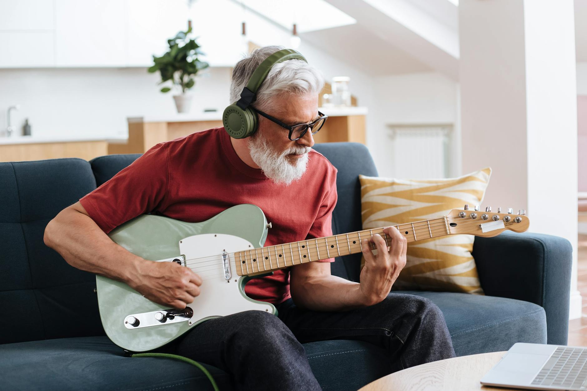 elderly man playing on electric guitar