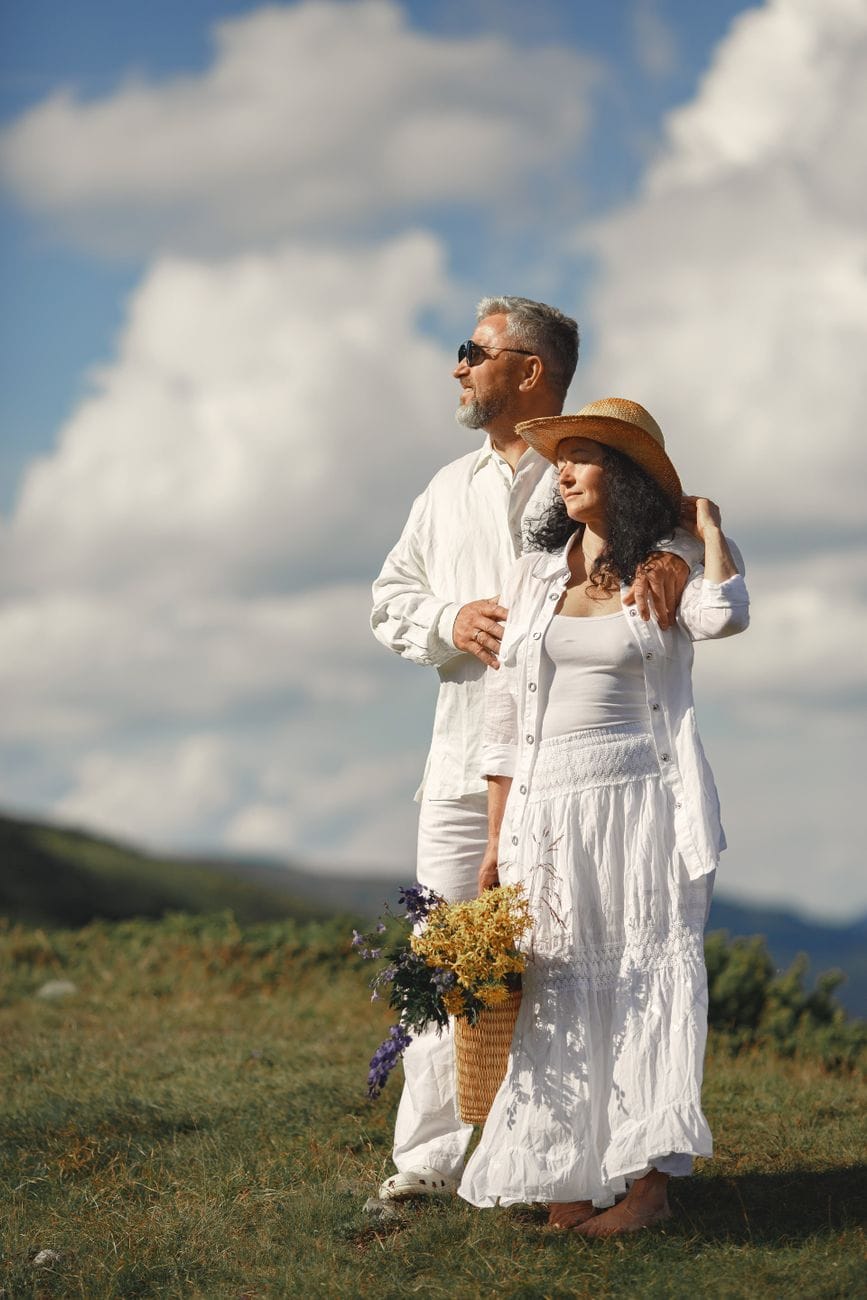 man in white dress shirt standing beside woman in white dress