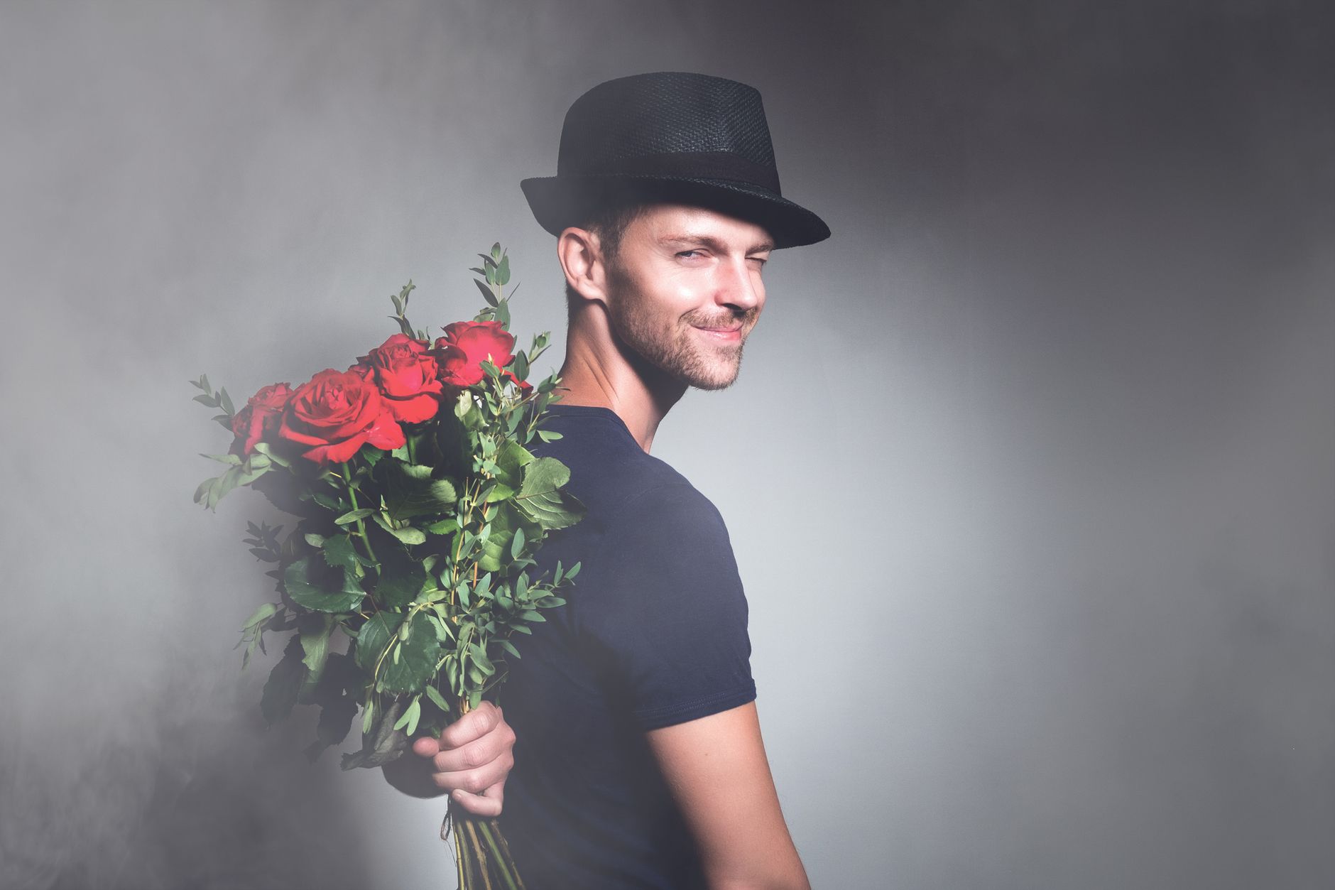man with bouquet of red roses